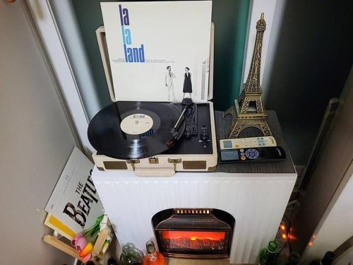 a refrigerator with a record player and the eiffel tower at Seeun house in Gwangju