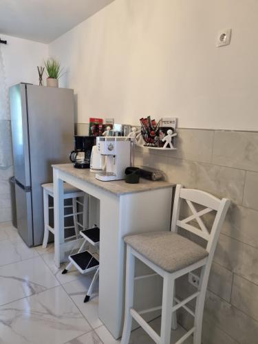 a kitchen with a counter with chairs and a refrigerator at Bruno 1 in Senj