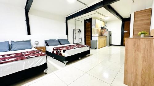 a large room with two beds and a kitchen at Malibu loft hotel in Medellín