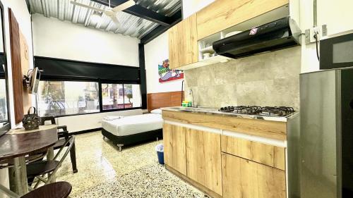 a kitchen with a stove and a table and a couch at Malibu loft hotel in Medellín