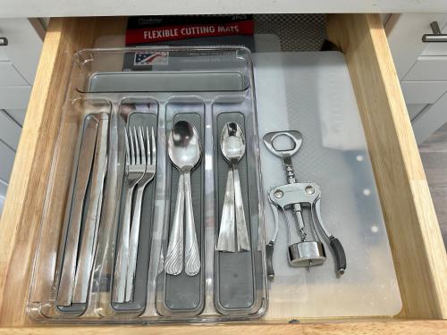 a drawer filled with utensils in a drawer at Getaway Private Suite C in Lutz
