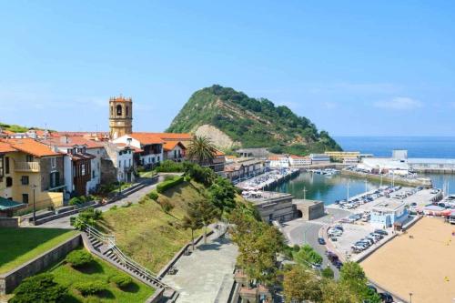 a town with a marina with boats in the water at LUR Apartments Getaria in Getaria