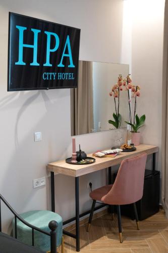 a sign for a hra city hotel hangs above a desk at IRA - ΗΡΑ Hotel in Kalamata