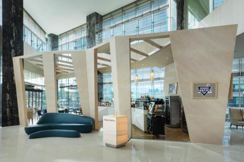a large lobby with a blue couch in a building at Wyndham Grand Istanbul Levent Hotel & Conference Center in Istanbul