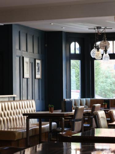a dining room with a table and chairs at The Porterhouse grill & rooms in Oxford