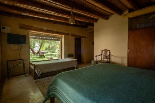 Postel nebo postele na pokoji v ubytování Aguaribay Tilcara