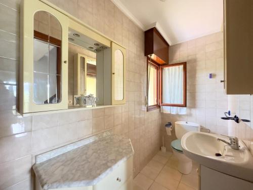 a bathroom with a sink and a toilet and a mirror at Casona de la Loma - 2806 in San Mamés de Meruelo
