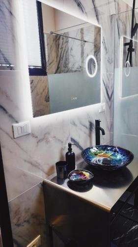 a bathroom counter with a sink and a mirror at Villetta Gloria in Venice-Lido