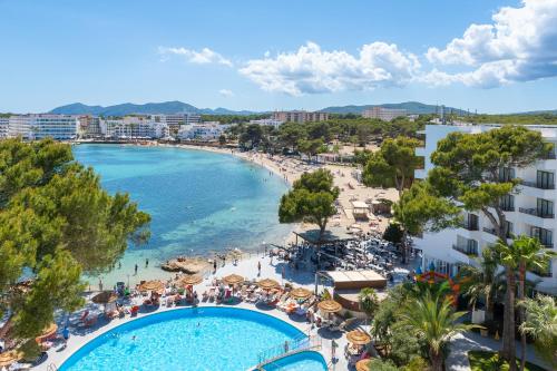 a view of a beach and a swimming pool at Leonardo Royal Hotel Ibiza Santa Eulalia in Es Cana
