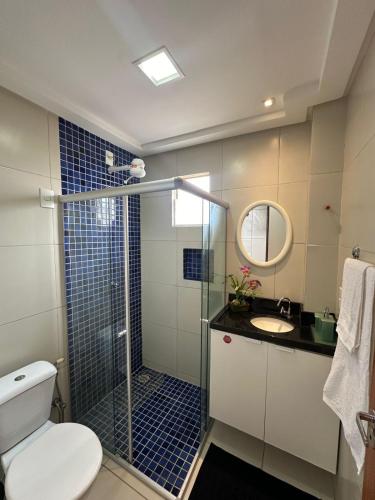 a bathroom with a shower and a toilet and a sink at Apartamento Cond Leão Dourado 01 in Caruaru