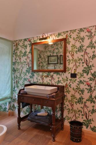 a bathroom with a tub and a mirror at Relais Scanno Green Home in Scanno