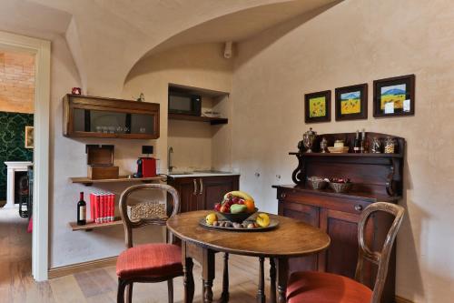 a kitchen with a table with a bowl of fruit on it at Relais Scanno Green Home in Scanno