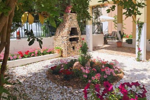 a garden with flowers in front of a building at Moloha in Skala Kallirakhis