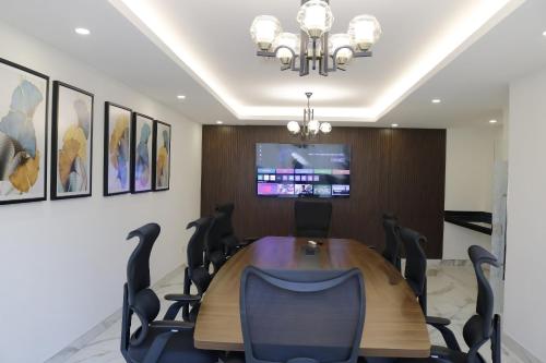 a conference room with a wooden table and chairs at Yaya Hotel & Apartments in Nairobi