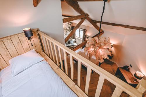 a bedroom with a bed and a wooden staircase at Hotel Centraal Baarlo in Baarlo