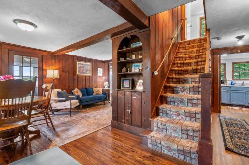 a living room with a staircase in a house at 39 Jefferson Shores Bourne - Vacation Bliss on Buttermilk Bay in Buzzards Bay
