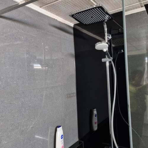 a shower in a bathroom with a glass wall at Magnifique appartement- Brussels expo Laeken in Brussels