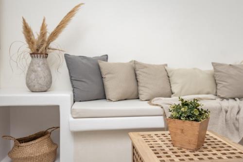 a living room with a couch and a table at Thea Suites Naxos in Agios Prokopios