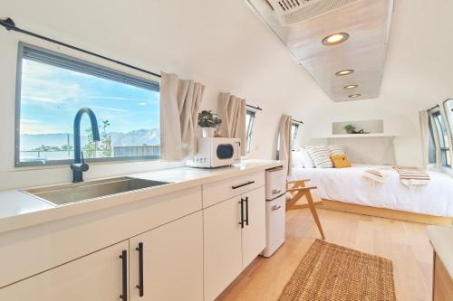 a kitchen with a sink and a bed in a room at Acres Landing in Desert Hot Springs