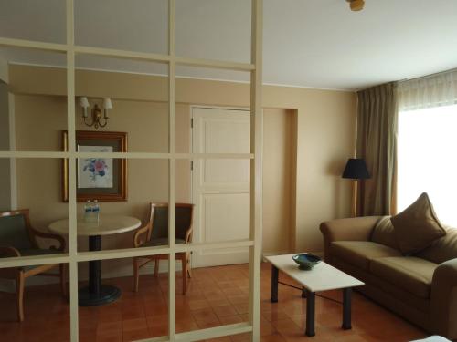 a living room with a couch and a table at Suites del Bosque Hotel in Lima