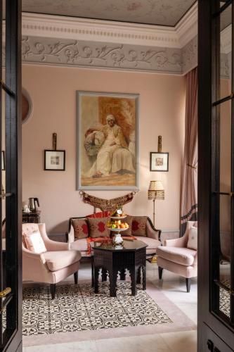 a living room with a painting on the wall at Palais Ronsard Relais & Chateaux in Marrakech