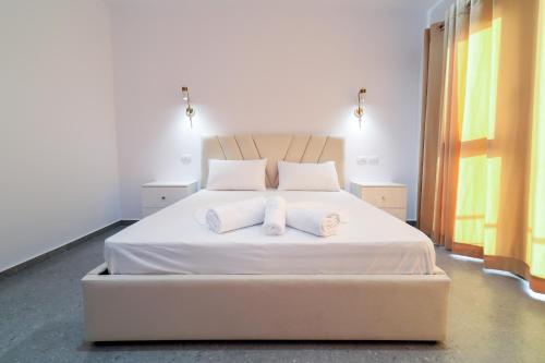 a bedroom with a bed with two pillows on it at Vila Dena in Vlorë