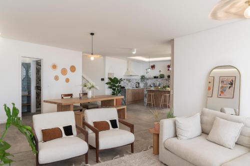 a living room with two chairs and a table at Islander - Funchal Seaside Villas in Funchal
