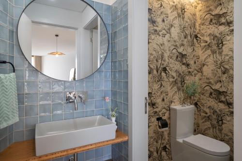 a bathroom with a sink and a mirror at Islander - Funchal Seaside Villas in Funchal