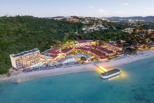 an aerial view of a resort and a boat in the water at Royalton CHIC Antigua, An Autograph Collection All-Inclusive Resort - Adults Only in Saint Johnʼs