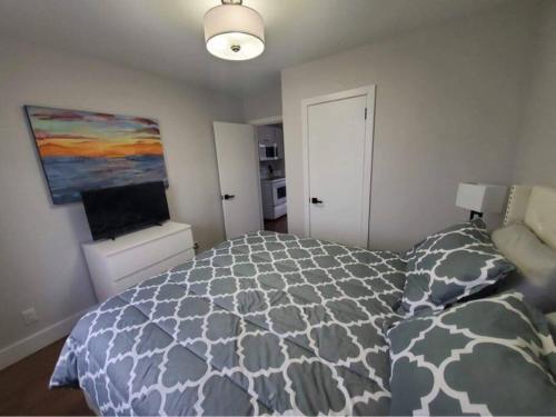 a bedroom with a bed and a painting on the wall at The Cabot Suite in Chéticamp