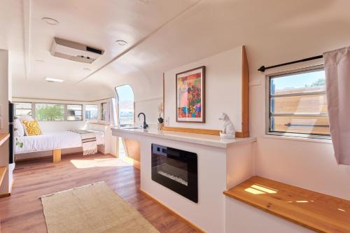 a living room with a fireplace in a tiny house at Acres Landing in Desert Hot Springs