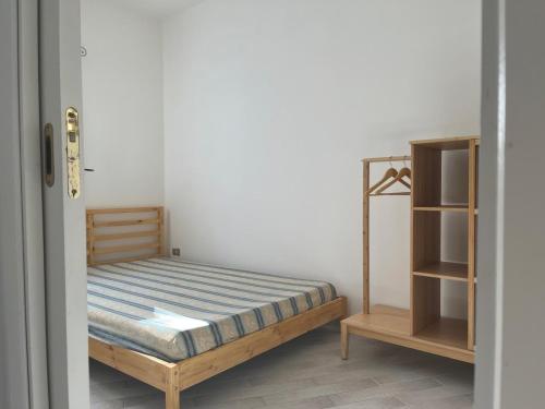 a bedroom with a bed and a book shelf at Da Masciu in La Maddalena