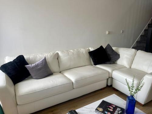 a white couch with pillows on it in a living room at Birks road in Cleator Moor