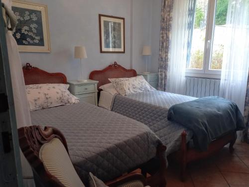 Una cama o camas en una habitación de B&B Le Camelie del Bosco