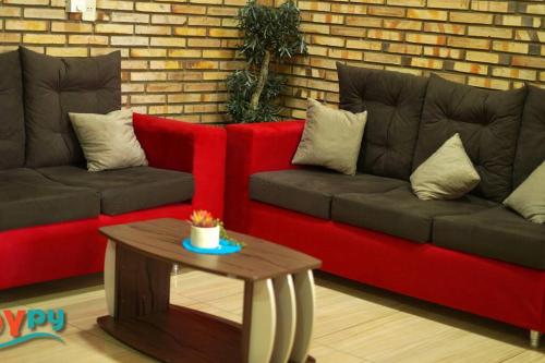 a living room with a red couch and a table at Sublime y moderno alojamiento in Barrio San Isidro (2)