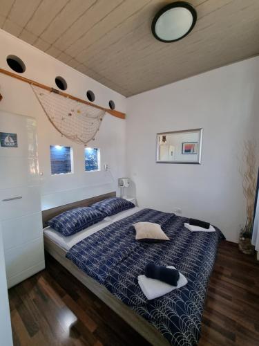 a bedroom with a bed with two pillows on it at SubCastrum Apartments in Pula