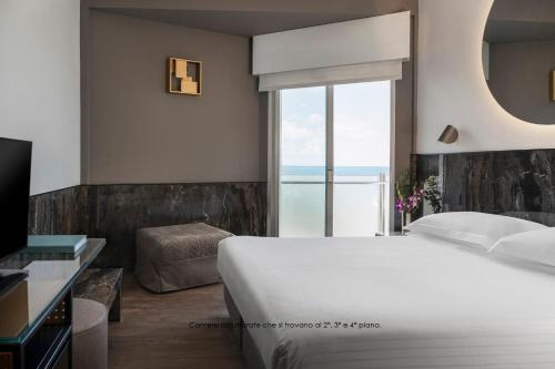 Postel nebo postele na pokoji v ubytování Hotel Michelangelo