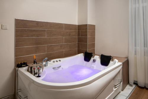 a white bath tub in a bathroom at Bakırk&ouml;y Zeugma Suit Otel in Istanbul