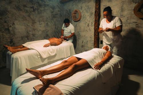 a man laying on a bed in a hospital room at Maya Tulum By G Hotels in Tulum