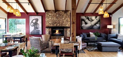 a living room filled with furniture and a fireplace at Elephant Hide of Knysna Guest Lodge in Knysna