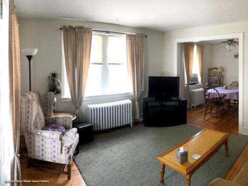 una sala de estar con un sofá y una mesa en Bryn Mawr Guest Suites, en Bryn Mawr