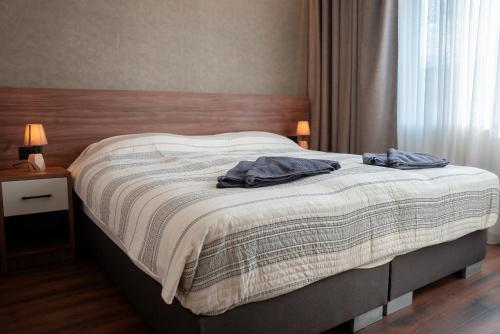 a bed in a bedroom with two towels on it at La Mer Apartments in Skopje