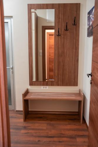 a bathroom with a wooden vanity and a mirror at La Mer Apartments in Skopje