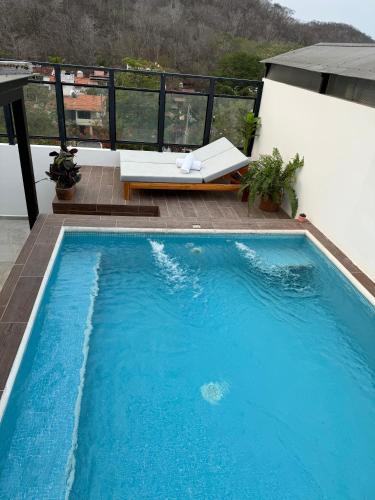 a large blue swimming pool on top of a building at Nabani Condominios T2 in Santa Cruz Huatulco