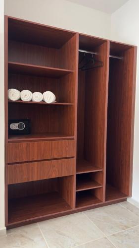 a wooden cabinet with three plates in it at Nabani Condominios T2 in Santa Cruz Huatulco