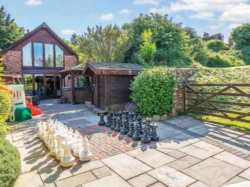 a garden with a chess set on a patio at The Linhay in Watchet