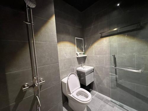 a bathroom with a toilet and a shower at Swing & Pillows - KLIA 1 KLIA 2, Sepang in Sepang