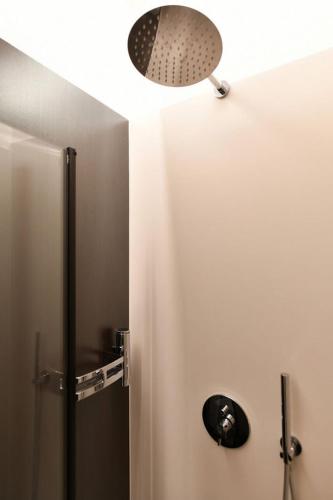 a bathroom with a shower and a light on the ceiling at Donna Eleonora Residence in Matera