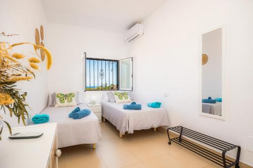 Giường trong phòng chung tại Finca Blanca