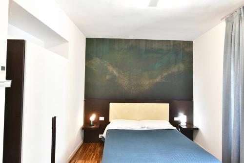 a bedroom with a bed and a painting on the wall at Donna Eleonora Residence in Matera